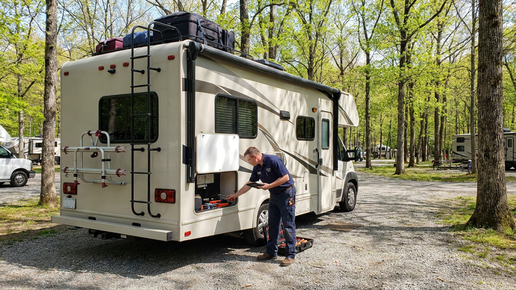 Mobile RV technician performing a pre-trip inspection on a Class C motorhome before a vacation.